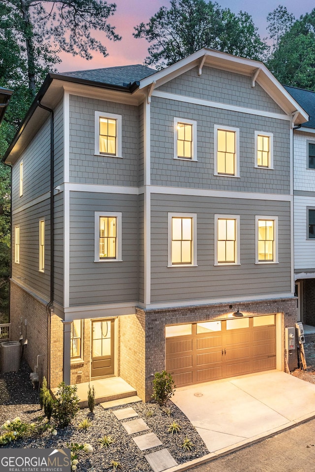 2164 James Aly, Atlanta, GA 30345 - townhome / multi-family property featuring brick siding, a garage, and driveway
