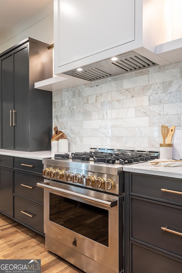 2164 James Aly, Atlanta, GA 30345 - kitchen with high end stove, light countertops, premium range hood, and decorative backsplash