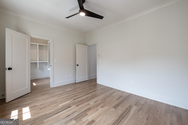 2164 James Aly, Atlanta, GA 30345 - unfurnished bedroom featuring crown molding, light wood-style flooring, a spacious closet, a closet, and a ceiling fan