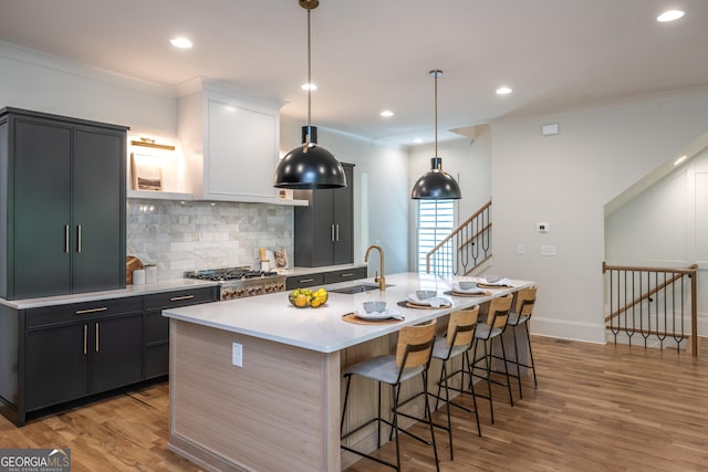 2164 James Aly, Atlanta, GA 30345 - kitchen featuring decorative backsplash, light countertops, light wood-type flooring, a kitchen bar, and crown molding