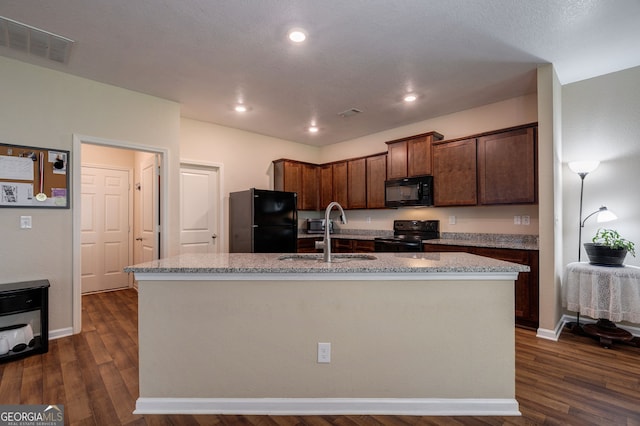 410 Meadowbend Cir, Athens, GA 30606 - kitchen with black appliances, dark wood-type flooring, a kitchen island with sink, light stone counters, and recessed lighting