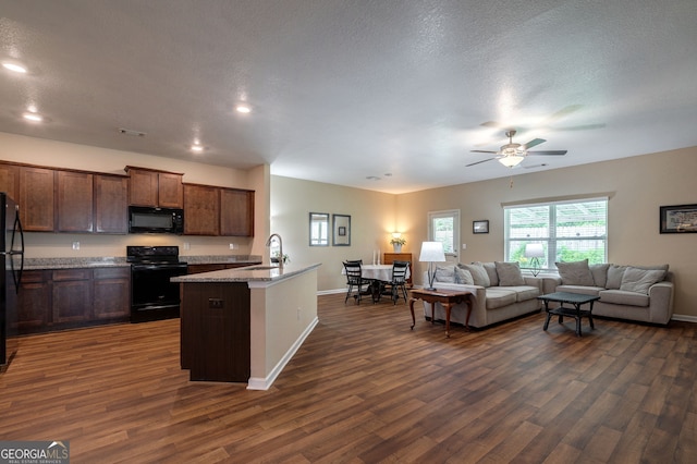 410 Meadowbend Cir, Athens, GA 30606 - kitchen with black appliances, open floor plan, dark wood-type flooring, a ceiling fan, and an island with sink