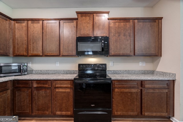 410 Meadowbend Cir, Athens, GA 30606 - kitchen featuring black appliances and wood finished floors