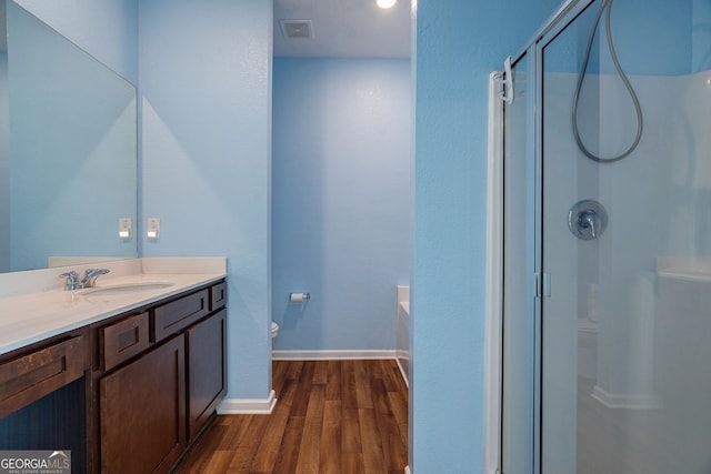 410 Meadowbend Cir, Athens, GA 30606 - bathroom featuring a shower stall, wood finished floors, vanity, and a garden tub