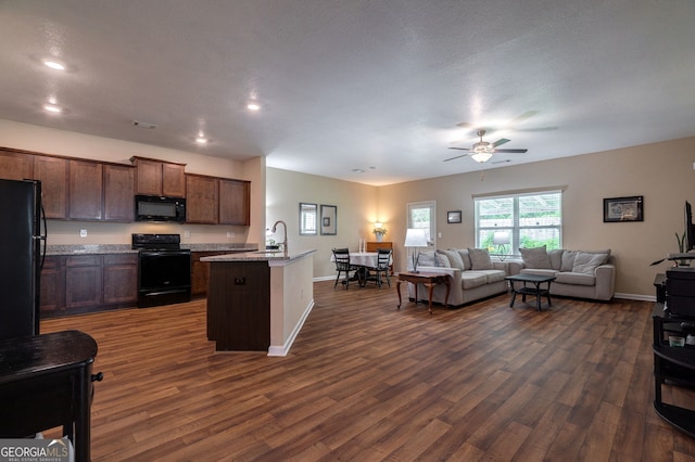 410 Meadowbend Cir, Athens, GA 30606 - kitchen with black appliances, open floor plan, a ceiling fan, dark wood-style floors, and a center island with sink