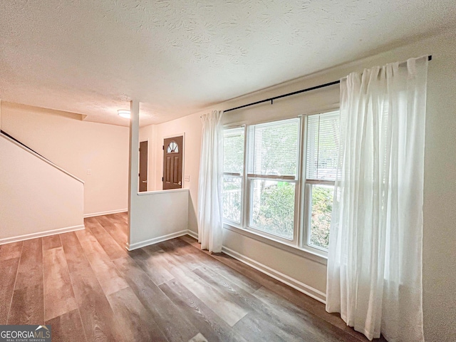 3150 Stratford Green Pl, Avondale Estates, GA 30002 - empty room with wood finished floors and a textured ceiling