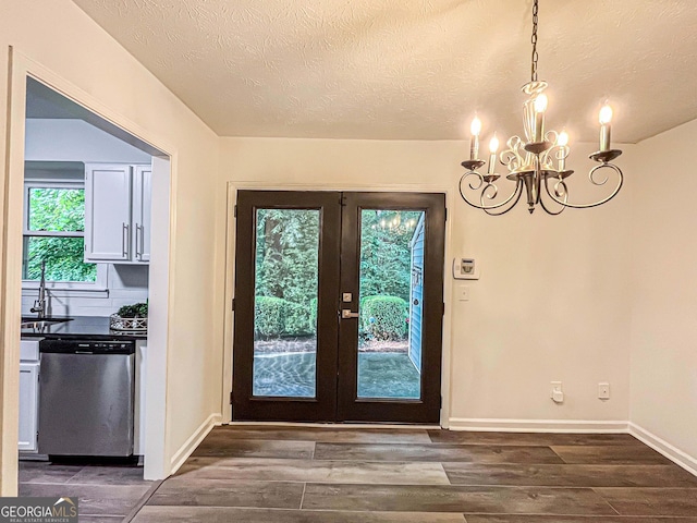 3150 Stratford Green Pl, Avondale Estates, GA 30002 - entryway with a chandelier, dark wood-type flooring, and a textured ceiling