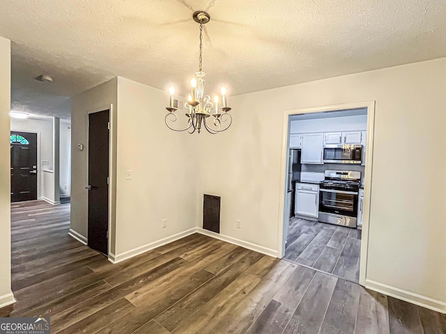 3150 Stratford Green Pl, Avondale Estates, GA 30002 - unfurnished dining area featuring dark wood-type flooring, a chandelier, and a textured ceiling