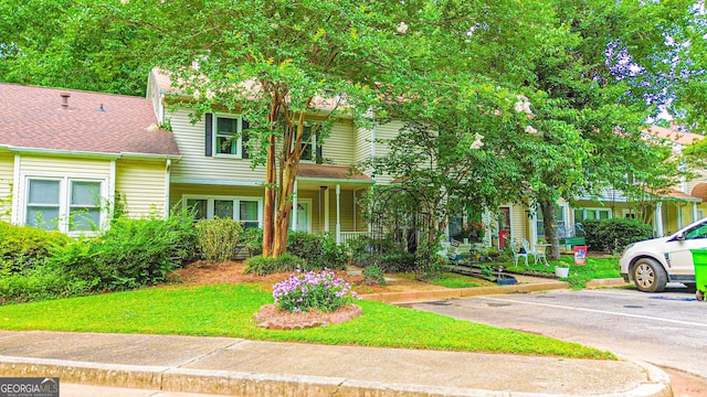 3150 Stratford Green Pl, Avondale Estates, GA 30002 - view of front of house with uncovered parking, a porch, and a front yard