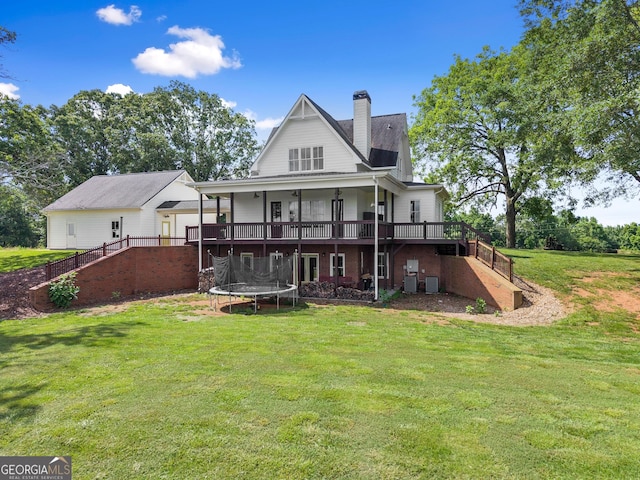 429 Hubert Harris Rd, Cornelia, GA 30531 - rear view of house with stairs, a trampoline, a deck, a yard, and a chimney