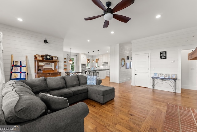 429 Hubert Harris Rd, Cornelia, GA 30531 - living area with a ceiling fan, light wood-style flooring, wood walls, recessed lighting, and decorative columns