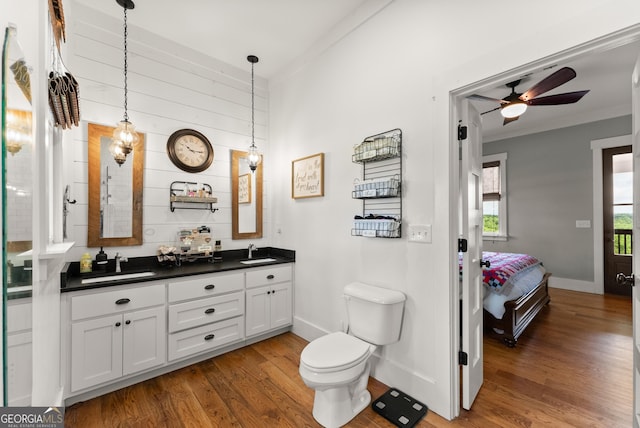 429 Hubert Harris Rd, Cornelia, GA 30531 - bathroom featuring wood finished floors, double vanity, ceiling fan, connected bathroom, and ornamental molding