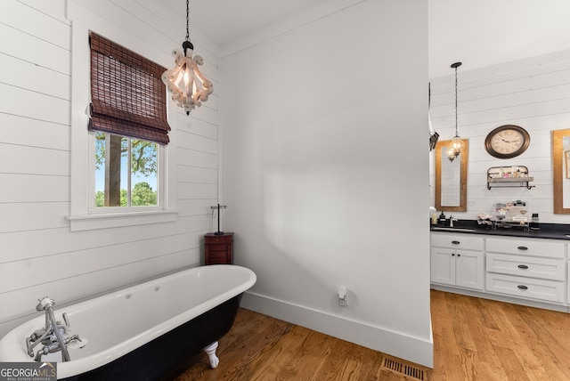 429 Hubert Harris Rd, Cornelia, GA 30531 - bathroom with vanity, a soaking tub, wood walls, and wood finished floors