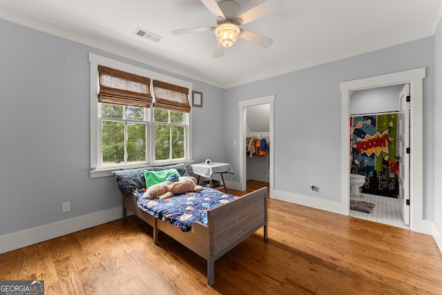 429 Hubert Harris Rd, Cornelia, GA 30531 - bedroom with light wood finished floors, a spacious closet, ensuite bathroom, and ceiling fan