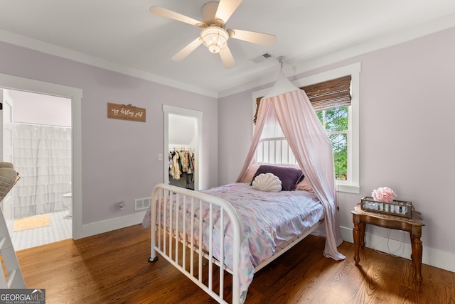 429 Hubert Harris Rd, Cornelia, GA 30531 - bedroom with a walk in closet, wood finished floors, a closet, connected bathroom, and a ceiling fan