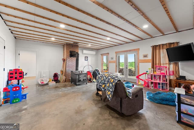 429 Hubert Harris Rd, Cornelia, GA 30531 - living room with a wood stove, french doors, unfinished concrete floors, a wall mounted air conditioner, and recessed lighting