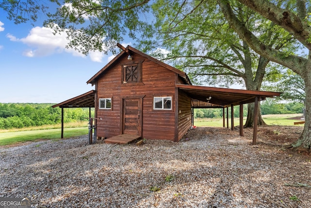429 Hubert Harris Rd, Cornelia, GA 30531 - view of outbuilding with gravel driveway and an attached carport