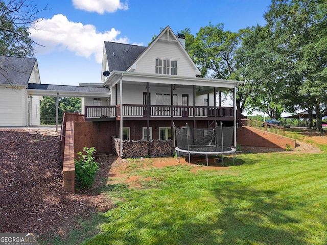 429 Hubert Harris Rd, Cornelia, GA 30531 - back of property featuring a trampoline, a chimney, a wooden deck, and a shingled roof