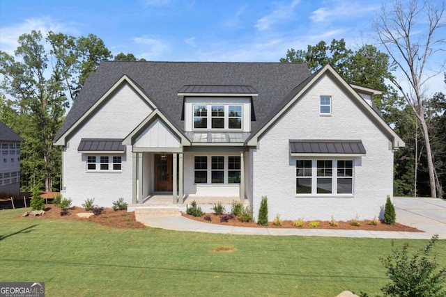 6750 Pannell Rd, Buford, GA 30518 - view of front of home featuring a standing seam roof, brick siding, a metal roof, and a front lawn