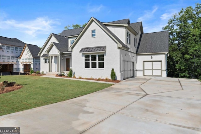 6750 Pannell Rd, Buford, GA 30518 - view of front of house with driveway, board and batten siding, a front yard, and a garage