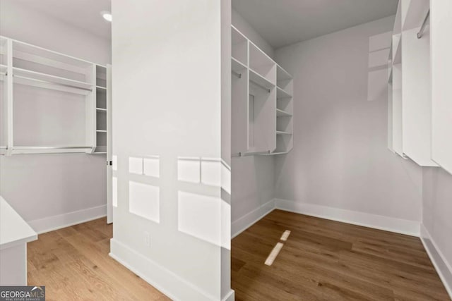 6750 Pannell Rd, Buford, GA 30518 - walk in closet with light wood-style floors