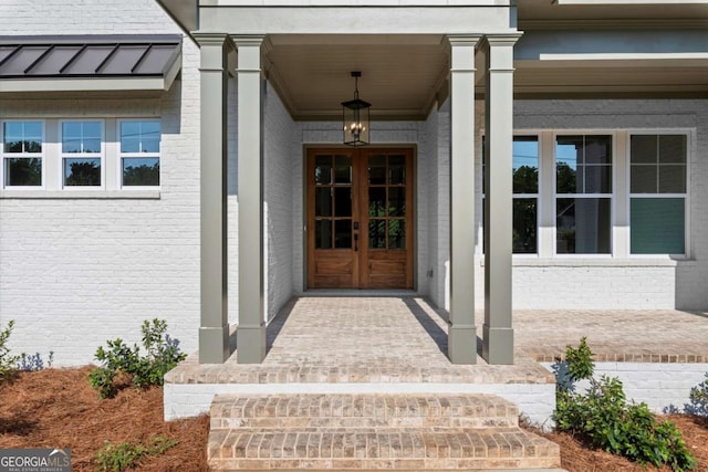 6750 Pannell Rd, Buford, GA 30518 - view of exterior entry featuring covered porch, french doors, and brick siding