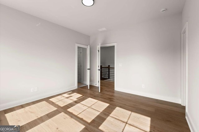 6750 Pannell Rd, Buford, GA 30518 - spare room with wood finished floors and a smoke detector
