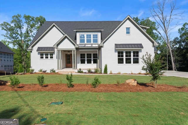 6750 Pannell Rd, Buford, GA 30518 - view of front of home featuring a standing seam roof, a front yard, and a metal roof