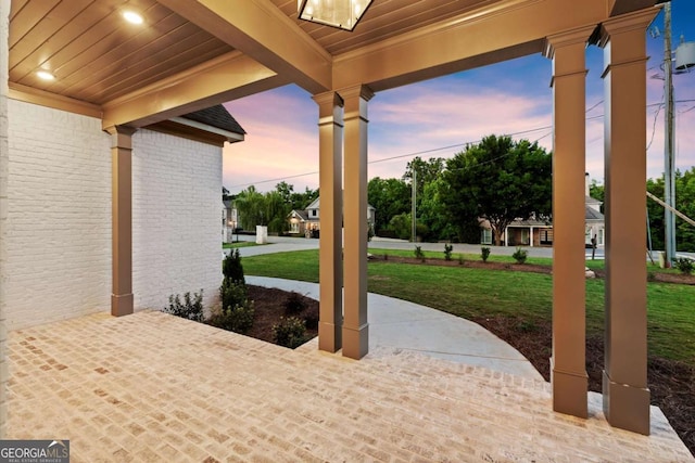 6750 Pannell Rd, Buford, GA 30518 - patio terrace at dusk featuring a lawn and covered porch