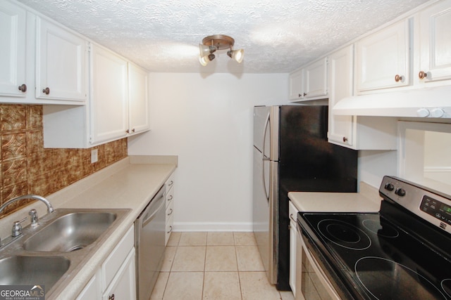 3101 Reeves St SE, Smyrna, GA 30080 - kitchen featuring appliances with stainless steel finishes, under cabinet range hood, white cabinetry, decorative backsplash, and light tile patterned floors
