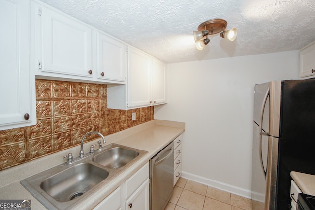 3101 Reeves St SE, Smyrna, GA 30080 - kitchen with stainless steel appliances, white cabinets, light tile patterned floors, light countertops, and a textured ceiling