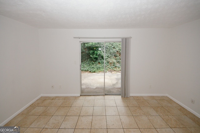 3101 Reeves St SE, Smyrna, GA 30080 - spare room featuring light tile patterned floors and a textured ceiling
