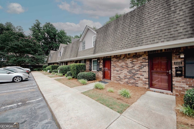 3101 Reeves St SE, Smyrna, GA 30080 - view of front of property with a shingled roof, uncovered parking, and brick siding