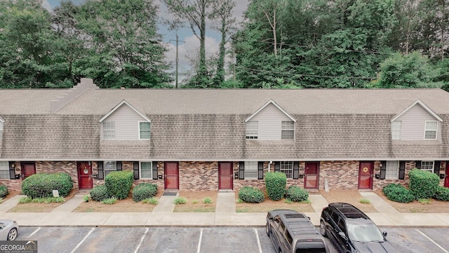 3101 Reeves St SE, Smyrna, GA 30080 - view of front of property with brick siding, uncovered parking, and a shingled roof