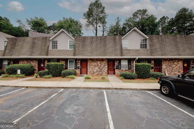 3101 Reeves St SE, Smyrna, GA 30080 - view of property with brick siding, uncovered parking, and roof with shingles