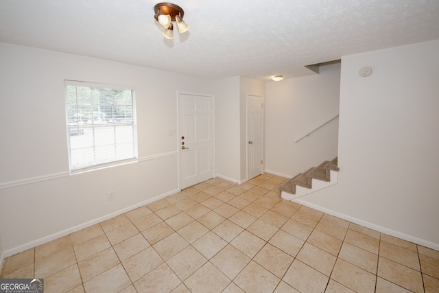3101 Reeves St SE, Smyrna, GA 30080 - foyer entrance with stairs, light tile patterned floors, and a textured ceiling