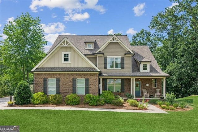 62 Saint Ives Cir, Winder, GA 30680 - craftsman-style home featuring covered porch, board and batten siding, brick siding, and a front yard