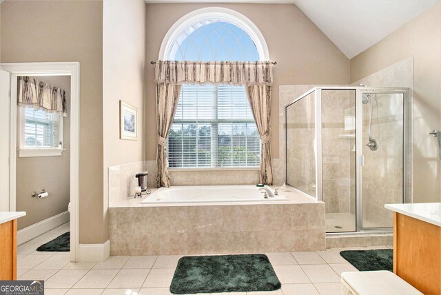 1209 Persimmon Way, Mcdonough, GA 30252 - bathroom featuring vanity, a bath, tile patterned floors, a stall shower, and lofted ceiling