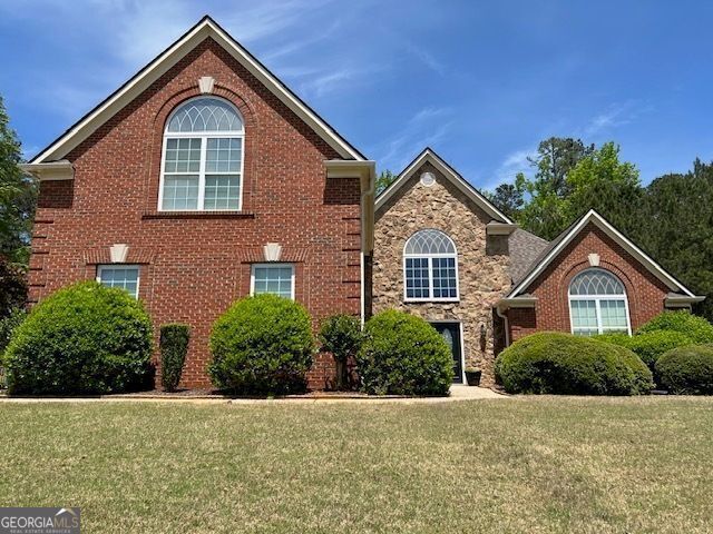 1209 Persimmon Way, Mcdonough, GA 30252 - traditional home with a front lawn and stone siding