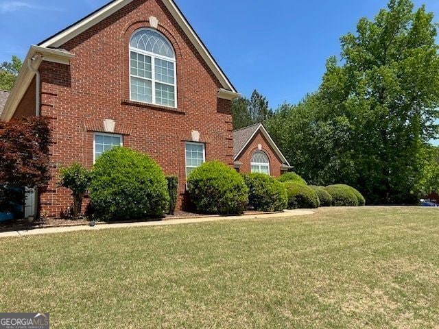 1209 Persimmon Way, Mcdonough, GA 30252 - view of side of property featuring a yard and brick siding