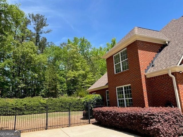 1209 Persimmon Way, Mcdonough, GA 30252 - view of side of home featuring roof with shingles and brick siding