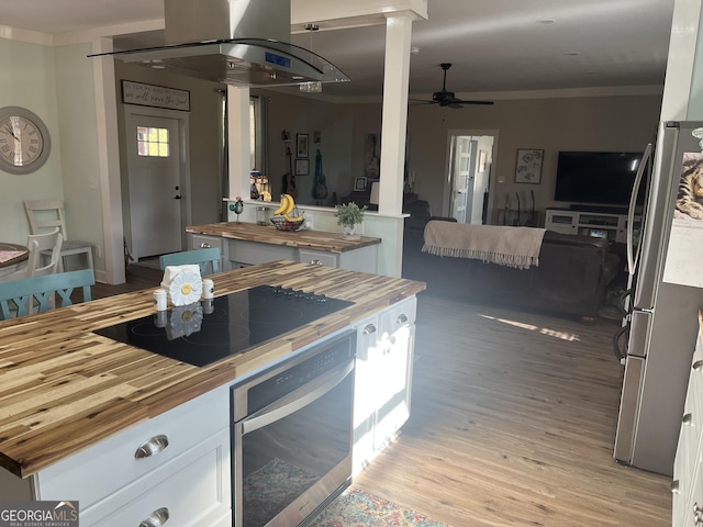 7191 Moontown Rd, Appling, GA 30802 - kitchen featuring butcher block countertops, freestanding refrigerator, wall oven, black electric cooktop, and ornate columns