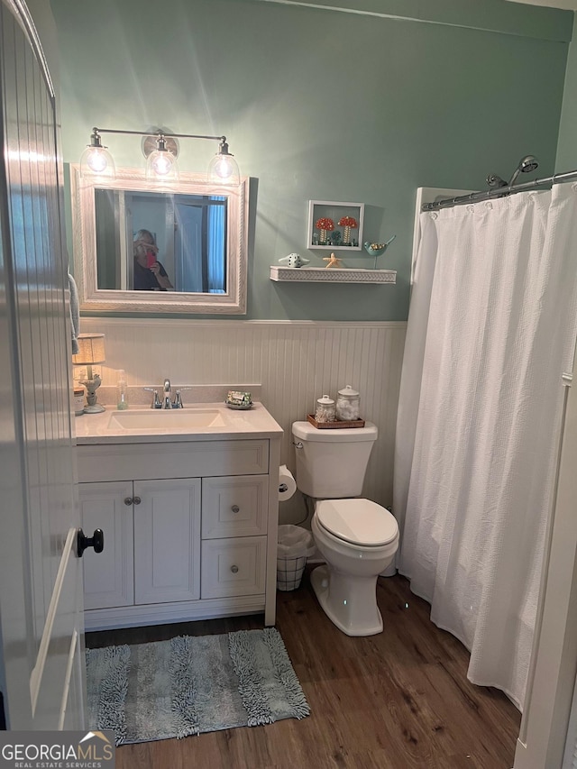 7191 Moontown Rd, Appling, GA 30802 - bathroom with wood finished floors, vanity, a wainscoted wall, and a shower with shower curtain