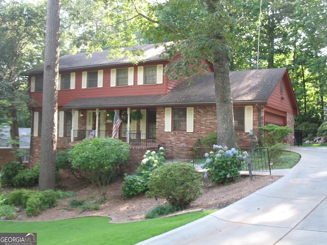 4098 Nancy Creek Way NE, Brookhaven, GA 30319 - view of front of property with brick siding, a porch, concrete driveway, and an attached garage