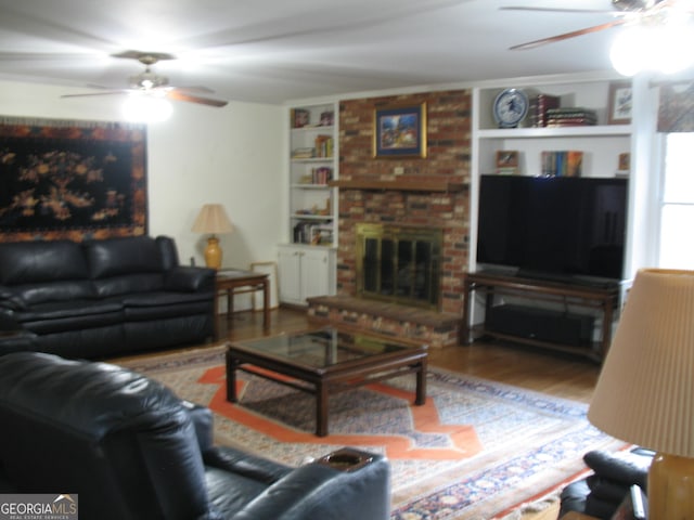 4098 Nancy Creek Way NE, Brookhaven, GA 30319 - living room featuring a ceiling fan, wood finished floors, a fireplace, and built in shelves