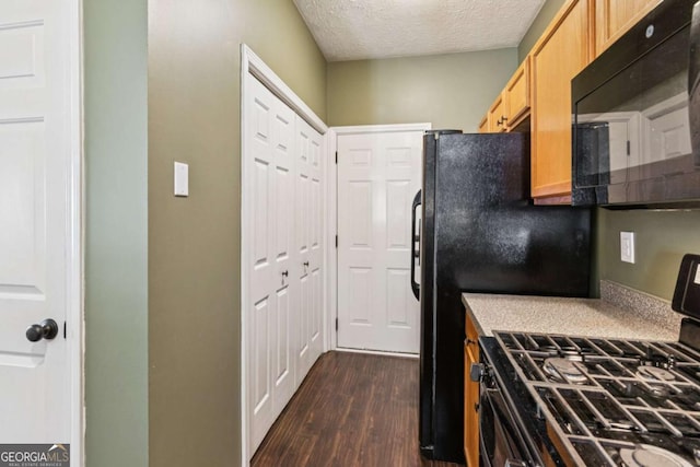 1714 Indian Way, Cumming, GA 30040 - kitchen with range with gas stovetop, black microwave, dark wood-style floors, a textured ceiling, and light brown cabinets