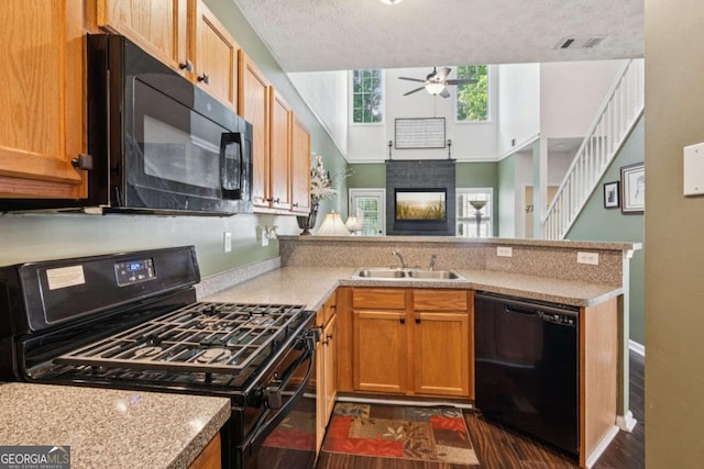 1714 Indian Way, Cumming, GA 30040 - kitchen with black appliances, a peninsula, ceiling fan, light countertops, and a textured ceiling