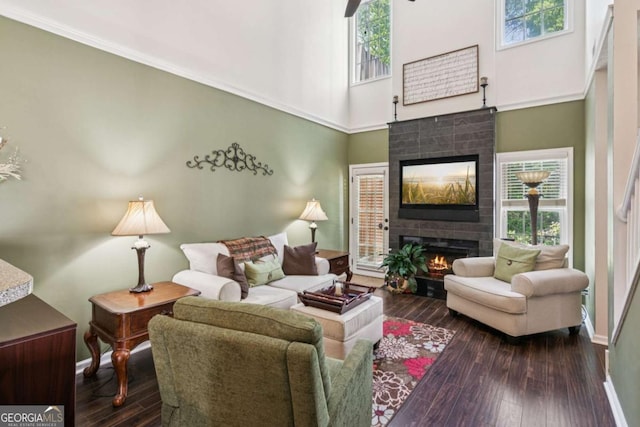 1714 Indian Way, Cumming, GA 30040 - living area featuring a tiled fireplace, hardwood / wood-style floors, and a towering ceiling