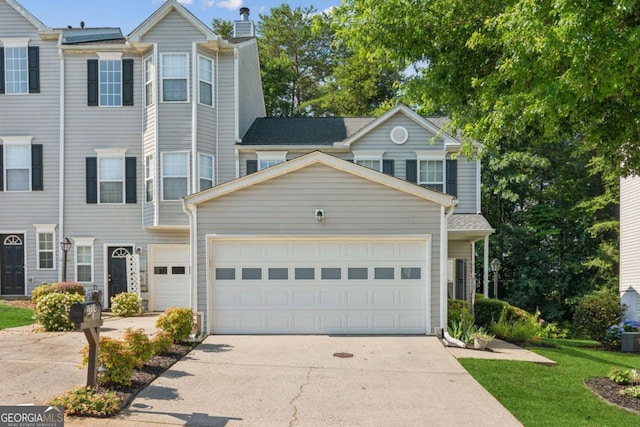 1714 Indian Way, Cumming, GA 30040 - townhome / multi-family property featuring concrete driveway, a garage, a chimney, and a front yard