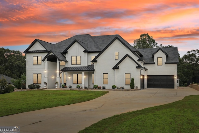 3735 Hamilton Mill Rd, Buford, GA 30519 - view of front facade featuring an attached garage, a standing seam roof, driveway, a lawn, and a metal roof